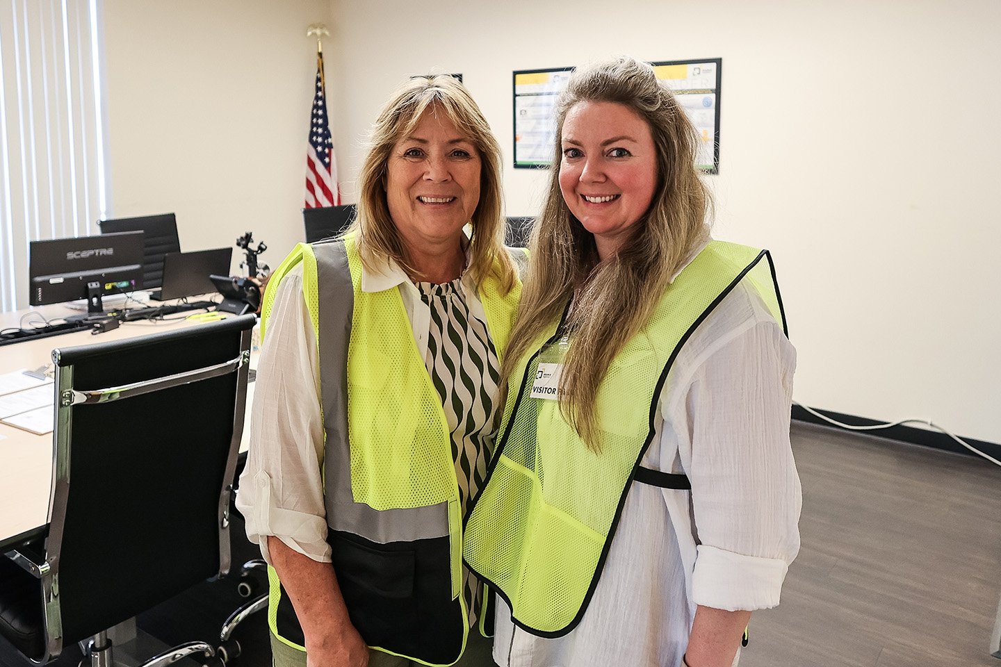 Two female executives from the Source Logistics leadership team pose for a professional portrait in front of an office